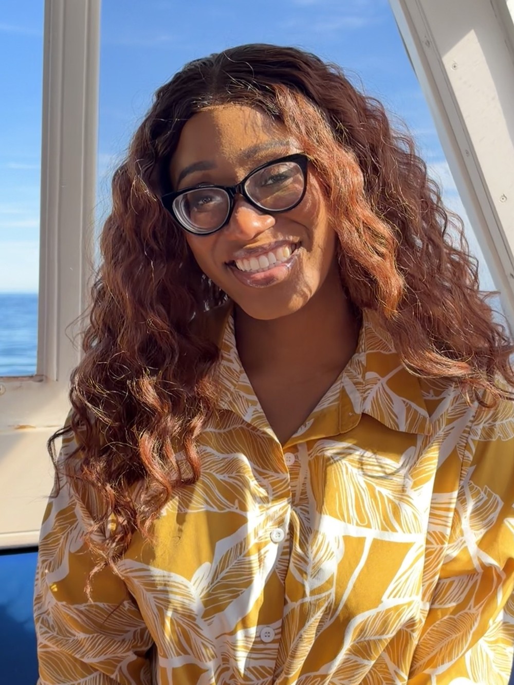 Ruova smiling in a golden shirt