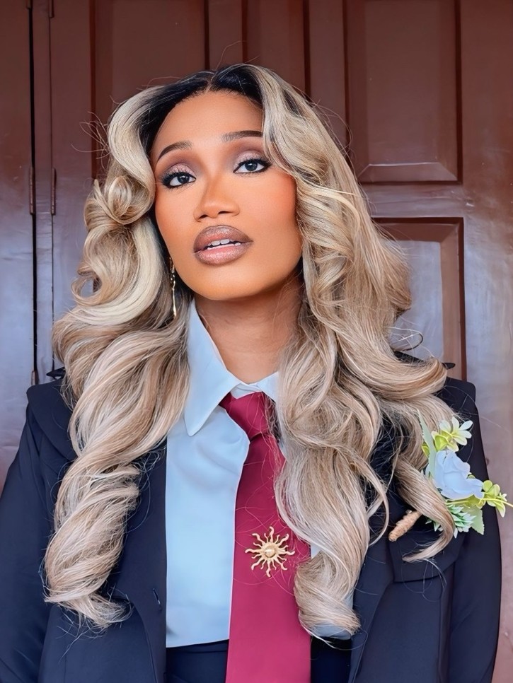Ruova in a navy suit and burgundy tie